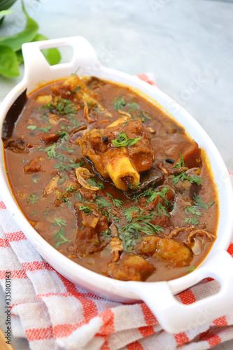 Mutton Kadai or Bhuna Gosht or Spicy Mutton curry is a famous Spicy nonvegetarian dish of India. Its made out of Lamb or Goat meat along with spices. Garnished with fresh coriander and fried onions.  photo