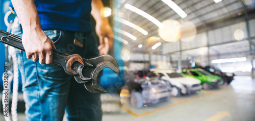 Blurred of car garage with cars maintenance and technicians for background