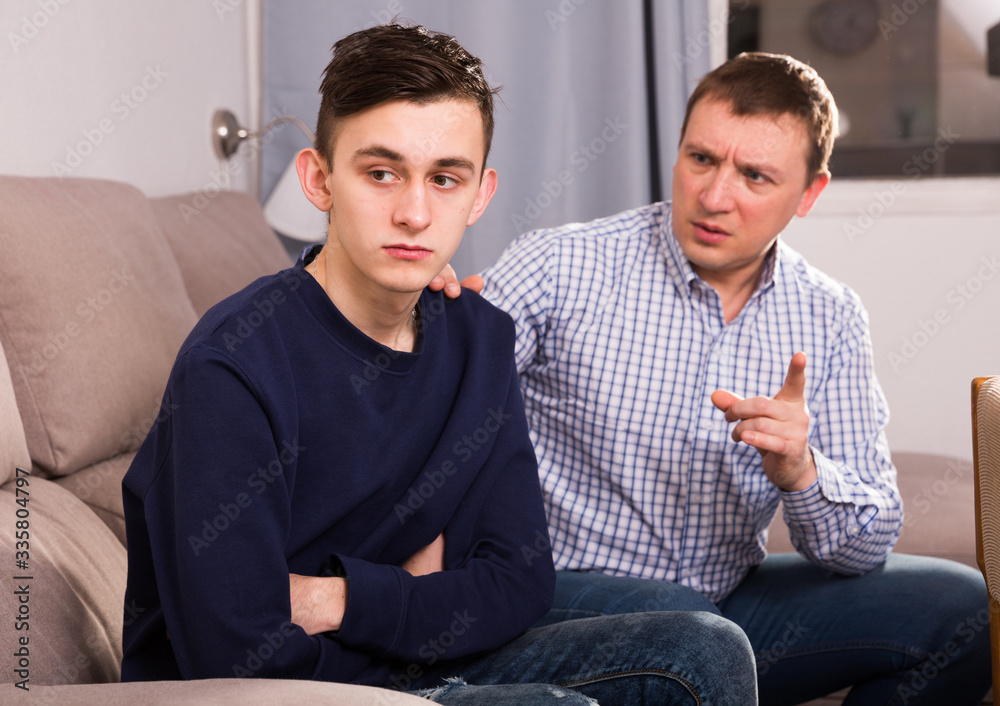 Fototapeta premium Boy is offended and father is asking for his forgiveness