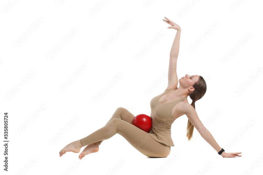 Slender girl gymnast with a red ball Isolated on a white background.