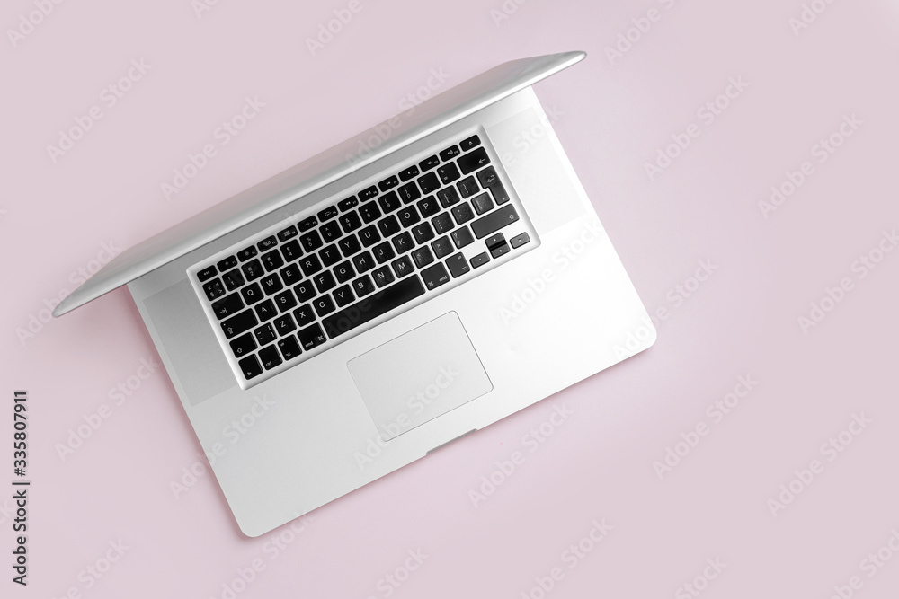 Laptop on a pink background. Work at home concept. Top view, flat lay Laptop on a pink background. Work at home concept. Top view, flat lay