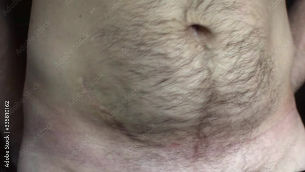 Fatty belly of a man. Obesity concept, time to do sports. A hand touches the stomach. Fatty belly of a man. Obesity concept, time to do sports. A hand touches the stomach.