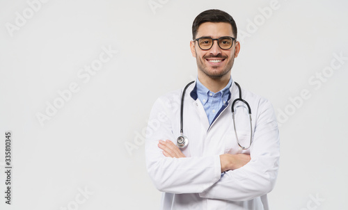 Horizontal banner of smiling young doctor ready to help patients with health problems, isolated on gray background with copy space on left