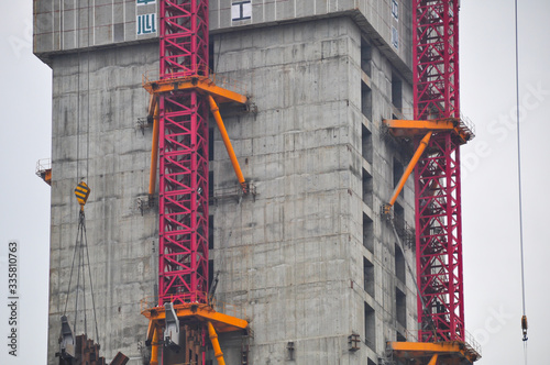 Construction site for the construction of a high-rise building in Shanghai, China. The red scaffolding is attached to the core of the building.