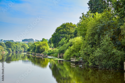 Image of the La vilaine River with trees and timber fishing platforms