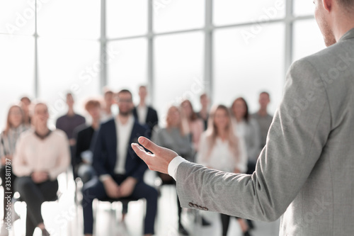 image of a speaker giving a lecture at a business seminar photo