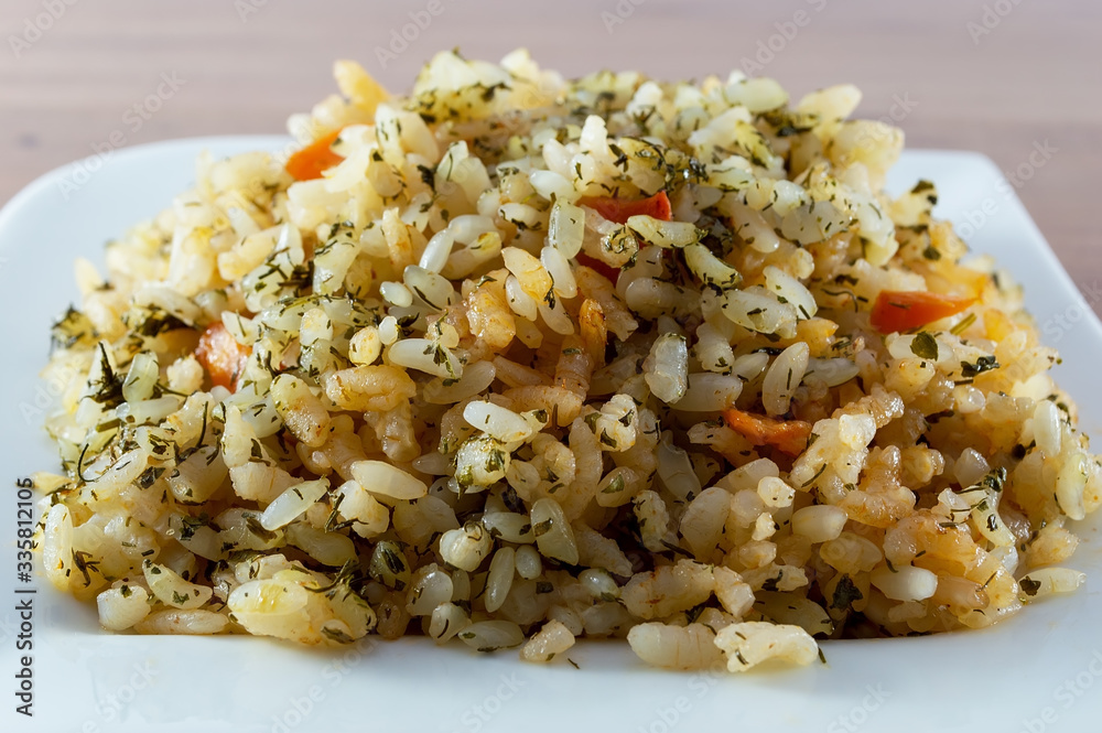 Rice with meat, vegetables and mushrooms on plate Rice with meat, vegetables and mushrooms on plate