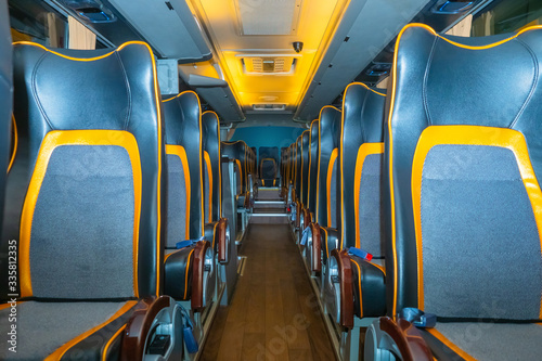 The interior of the bus. Leather seats. The concept is comfort in Autobus traffic. Public transport. Carriage of passengers. Traveling by bus. Luxury class public transport. Seats in a tourist bus.