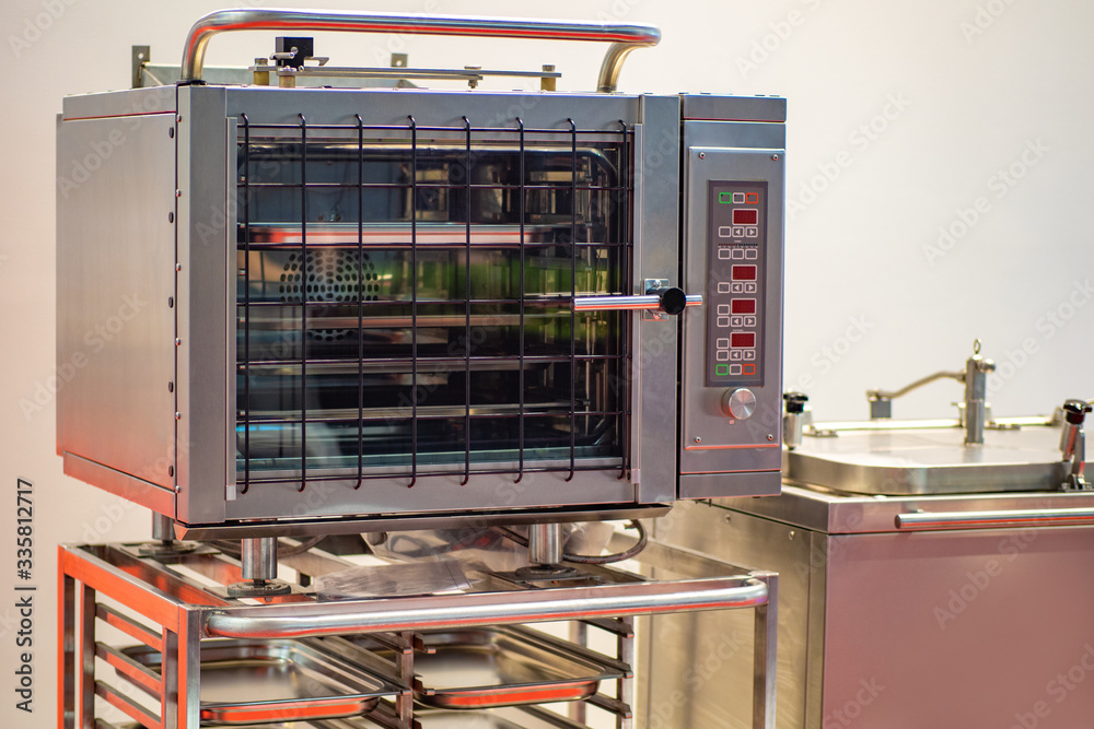 Combi Oven. Combi oven in a catering company. Equipment for restaurants. Combi oven in the restaurant kitchen. Industrial stove. Food production. Electrical Equipment Manufacturing. Stove in a cafe