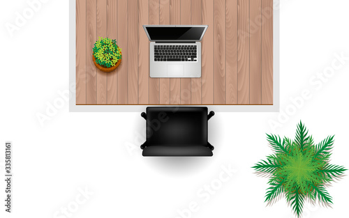 topview notebook and plant on the wooden table in the work room