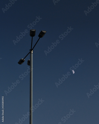 Street lamp and blue sky and moon