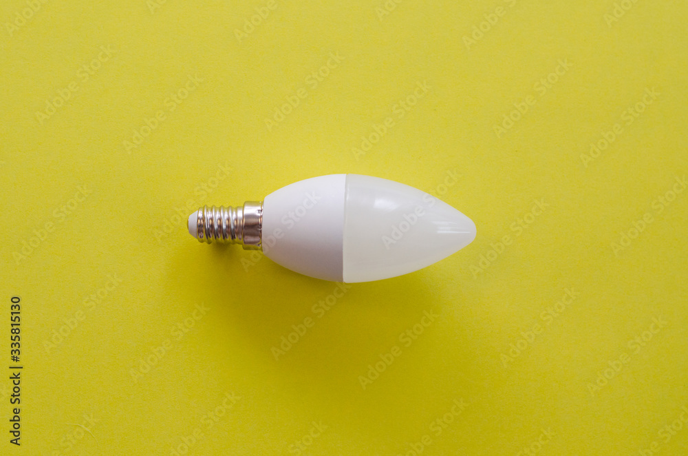 white LED light bulb on a yellow backgroundwarm white LED light bulb on a yellow backgroundwarm