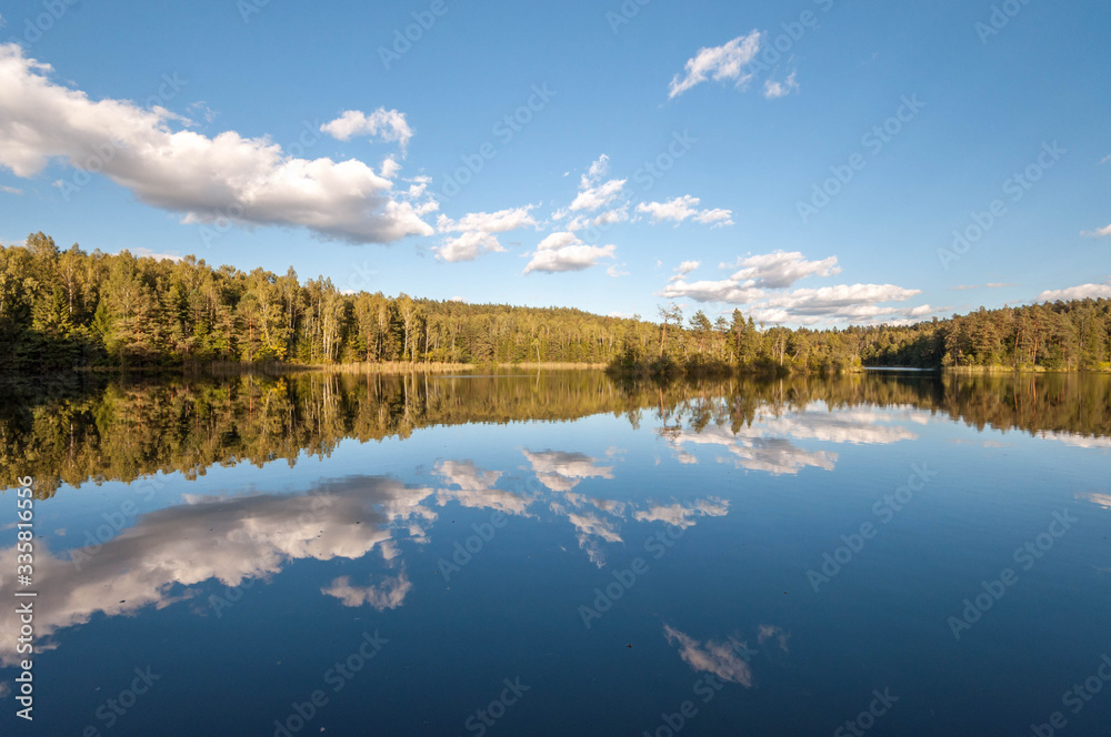 Perfect reflection of the Blue Lakes of Belarus . Autumn season is coming. Bear country. Beautiful landscape background concept.