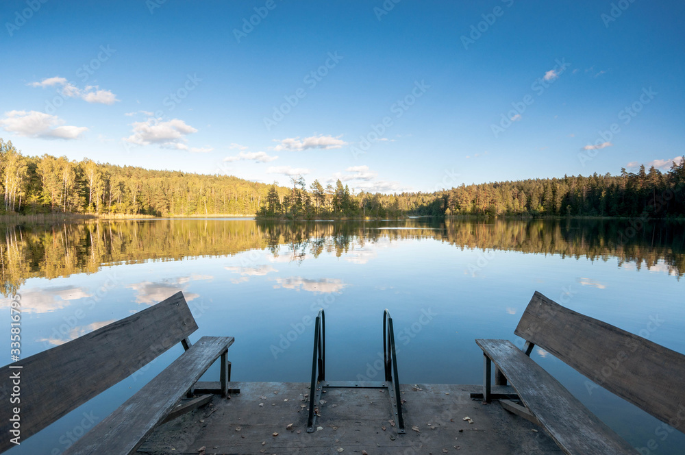 Naklejka premium Perfect reflection of the Blue Lakes of Belarus . Autumn season is coming. Bear country. Beautiful landscape background concept.