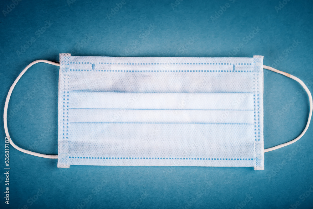 The epidemic of coronavirus. Medical mask on the table. Background with copy space. Horizontal. The epidemic of coronavirus. Medical mask on the table. Background with copy space. Horizontal.