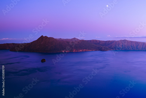 beautiful morning caldera lake with moon