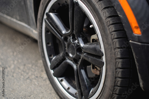Car wheel close up. Big car wheel. Black big car wheel close up. Car tire close up