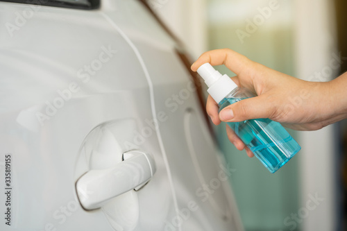 inject alcohol spray hand pull to open the car door and frequently touched area for cleaning and disinfection, prevention of germs spreading during infections of COVID-19 coronavirus