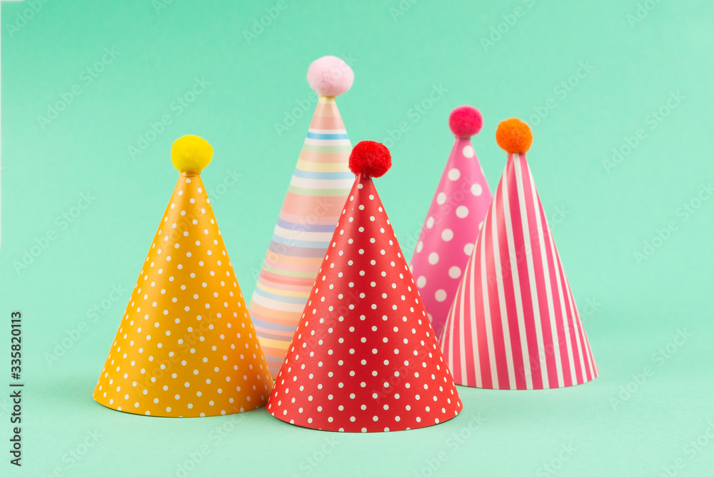 Colorful birthday caps on mint background. Colorful birthday caps on mint background.