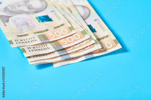 Ukrainian money on blue background. Payment of pensions, salaries. Bank loan. Business concept