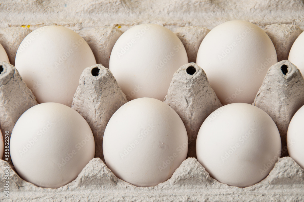 Chicken eggs in tray on a yellow background, copy space Chicken eggs in tray on a yellow background, copy space