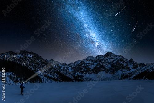 Stunning Morskie Oko mountain lake in winter and milky way