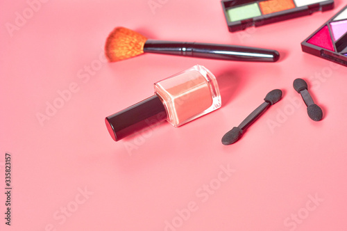 Set of different cosmetics accessories lies on pink countertop in salon. Beauty and fashion concept. Face care