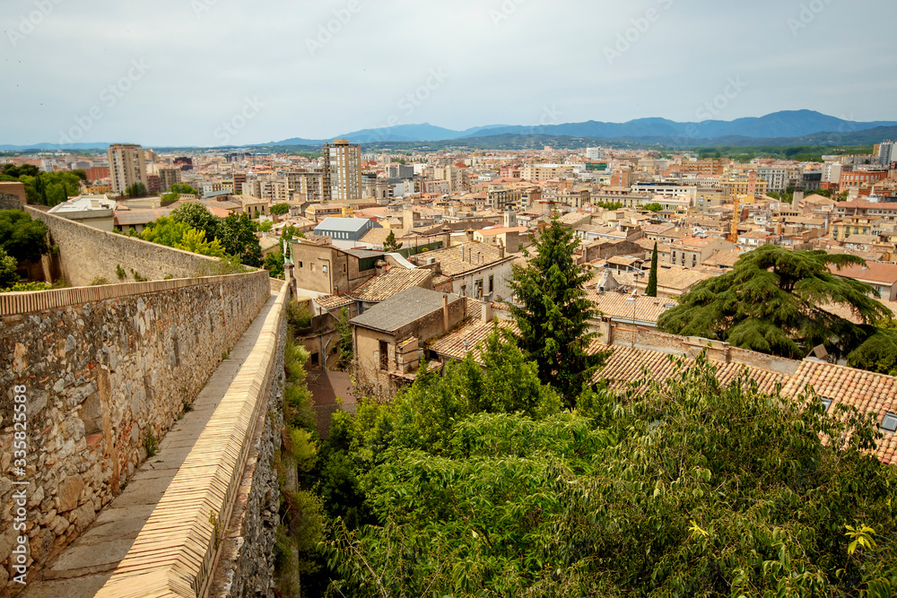 Girona old city wall fortification, venerable 9th-century city walls with walkways, towers and scenic points of the area, city views of Girona, Catalonia, Spain