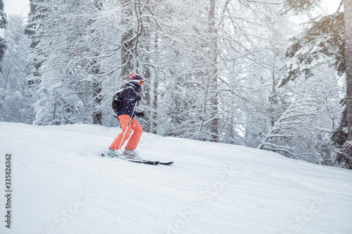 Young woman skiing under snowfall