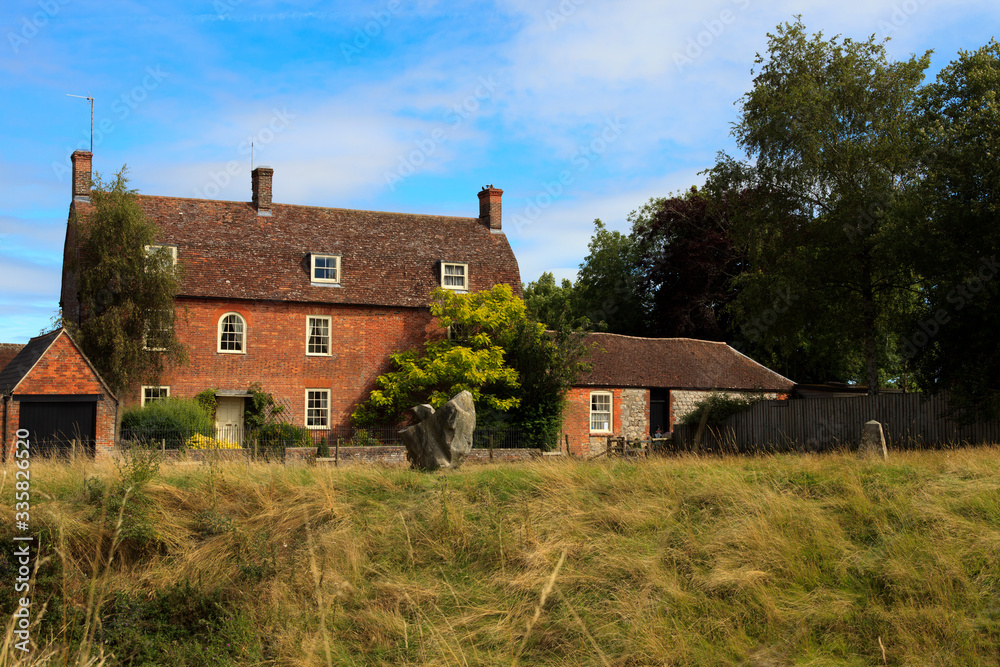 Avebury (England), UK - August 05, 2015: A typical house in Avebury village, Wiltshire , England, United Kingdom. Avebury (England), UK - August 05, 2015: A typical house in Avebury village, Wiltshire , England, United Kingdom.