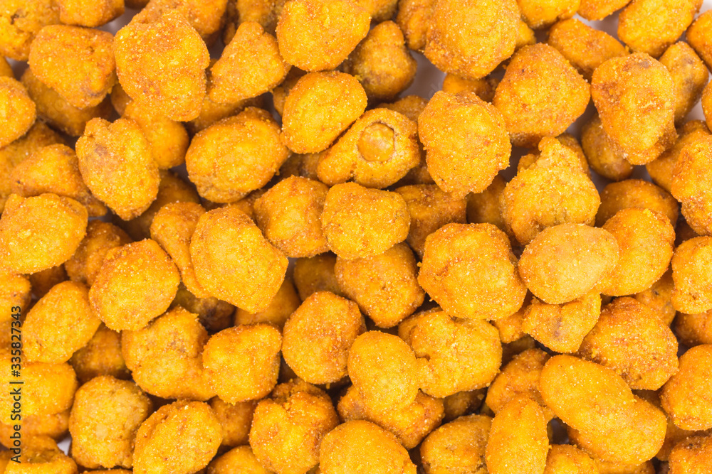 background of roasted peanuts with paprika coating background of roasted peanuts with paprika coating