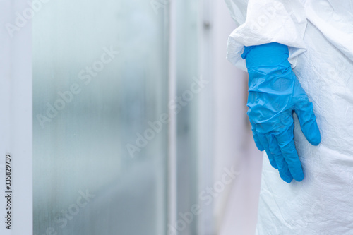 close up picture of hand in gloves of doctor wearing personal protective equipments in the hospital. covid-19, coronavirus, medical, healthcare, quarantine concept