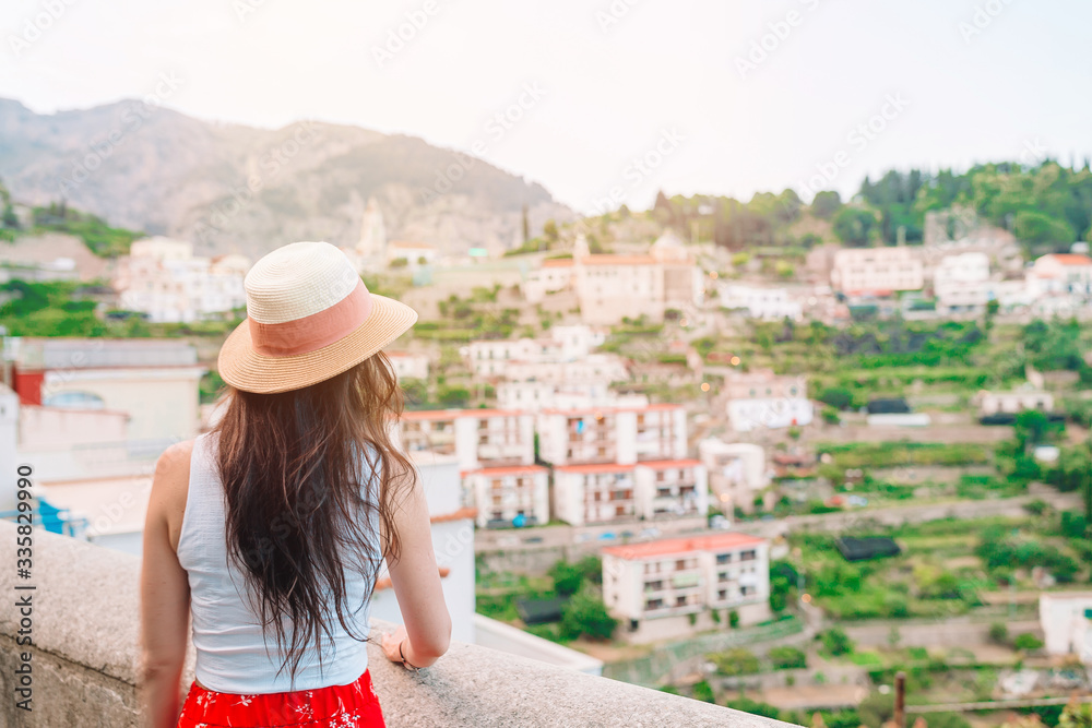 Summer holiday in Italy. Young woman in Positano village on the background, Amalfi Coast, Italy