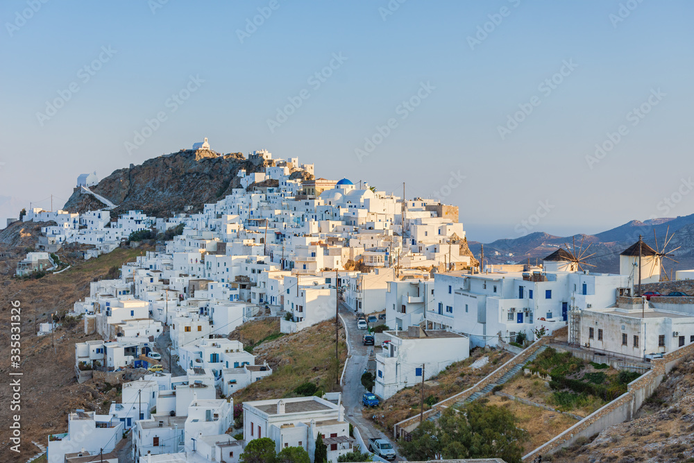 The chora - capital with traditional white houses of Serifos island Aegean Cyclades Greece against a blue sky on sunset