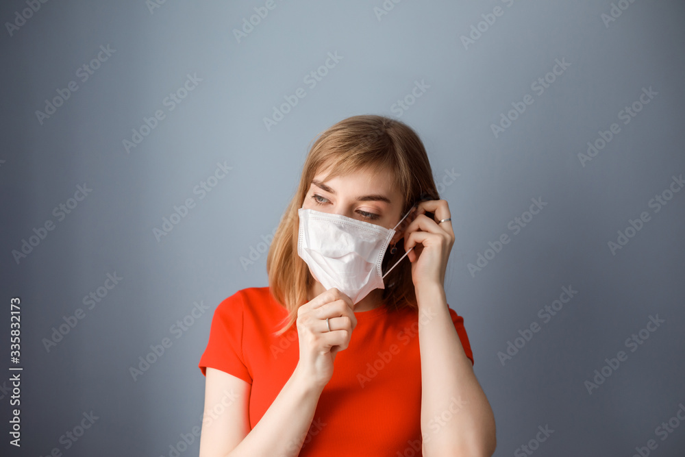 Caucasian woman puts on medical mask. Health care, protecting from covid 19, coronavirus, flu. Protecting health from allergy. Caucasian woman puts on medical mask. Health care, protecting from covid 19, coronavirus, flu. Protecting health from allergy.