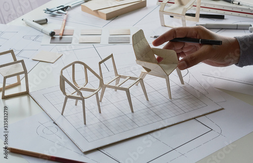 Designer sketching drawing design development product plan draft chair armchair Wingback Interior furniture prototype manufacturing production. designer studio concept . photo