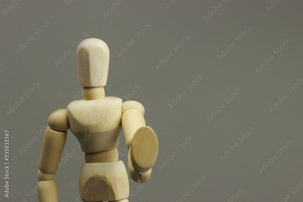 Wooden figure making stop sign on a gray background. Concept Wooden figure making stop sign on a gray background. Concept