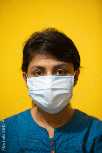 A young girl wearing a surgical facemask.  photo
