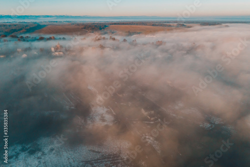 Foggy winter morning in mountain village with top view