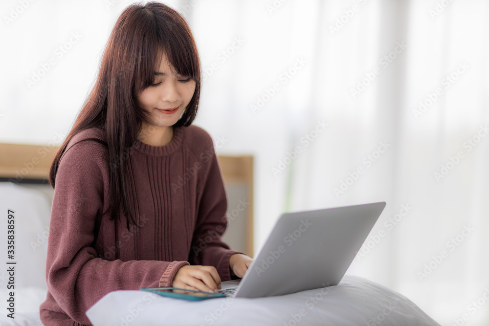 Asian woman using laptop for working, educational, e-commerce, social media in her bed. corovavirus covid-19, stay at home, work form home concept. Asian woman using laptop for working, educational, e-commerce, social media in her bed. corovavirus covid-19, stay at home, work form home concept.