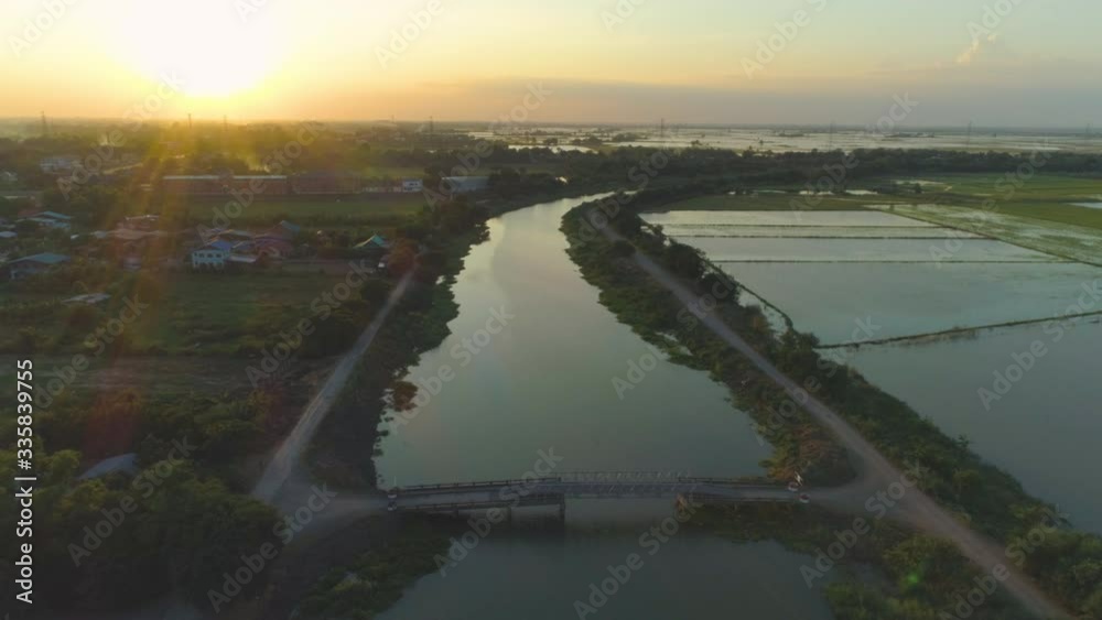 Shot from above ,Sunset on city and rice field flooded with water countryside Thailand. Shot from above ,Sunset on city and rice field flooded with water countryside Thailand.