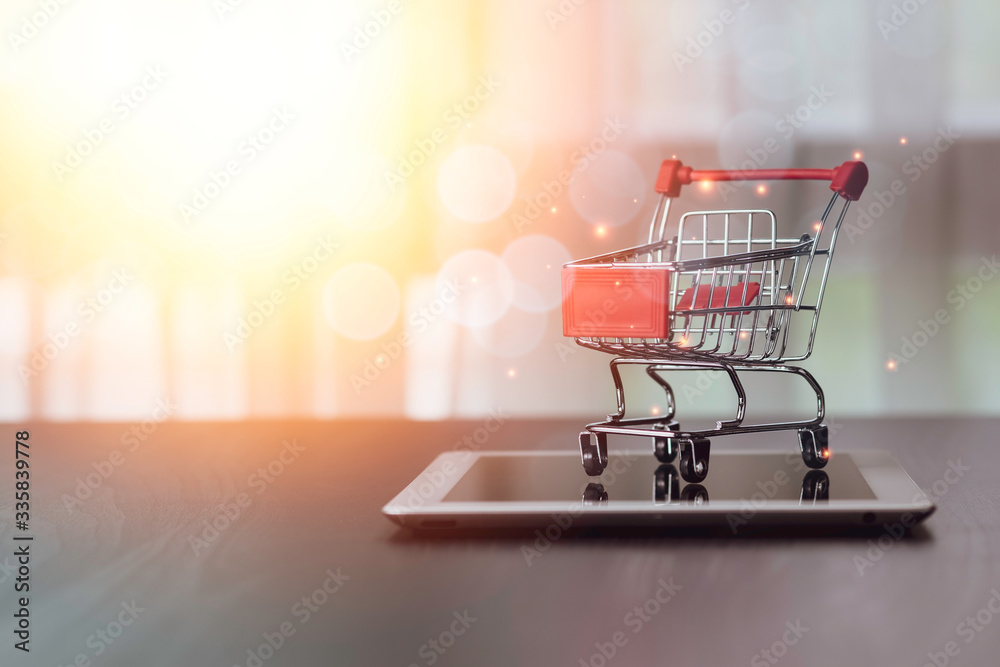 Closeup of shopping cart on parking on tablet. Online shopping and work from home concept.