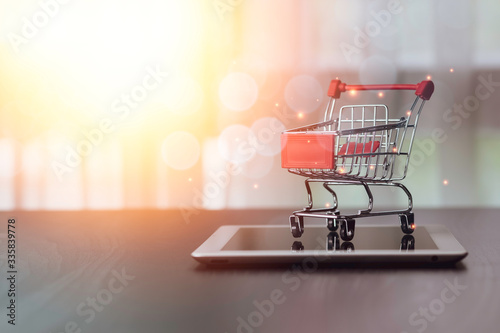 Closeup of shopping cart on parking on tablet. Online shopping and work from home concept.