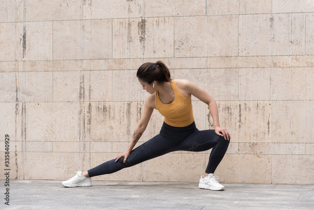 A young Asian woman is doing warm-up exercises A young Asian woman is doing warm-up exercises