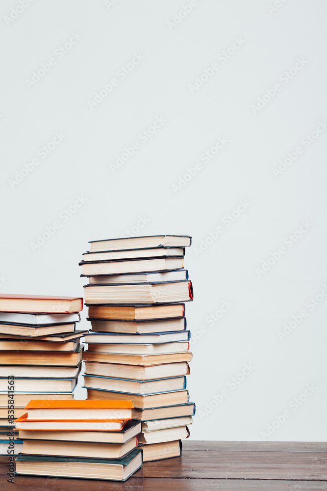 many stacks of educational books at home preparing for exams on a white background