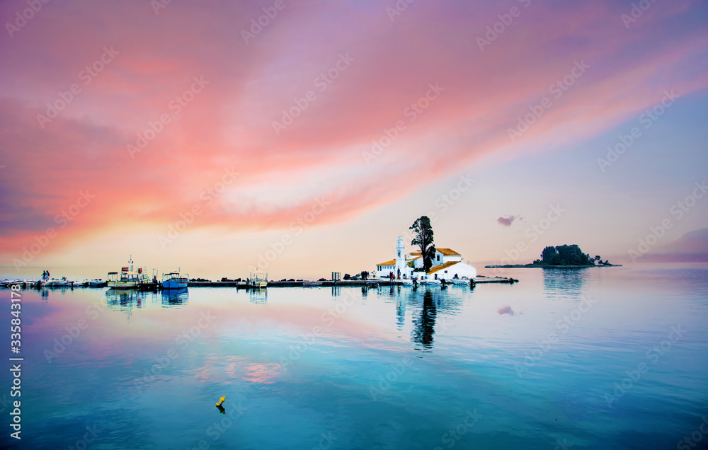 Nice optimistic view of Vlacherna Monastery on the Kanoni peninsula in Kerkyra, Corfu, Greece at sunset. popular tourist attractions. amazing places.