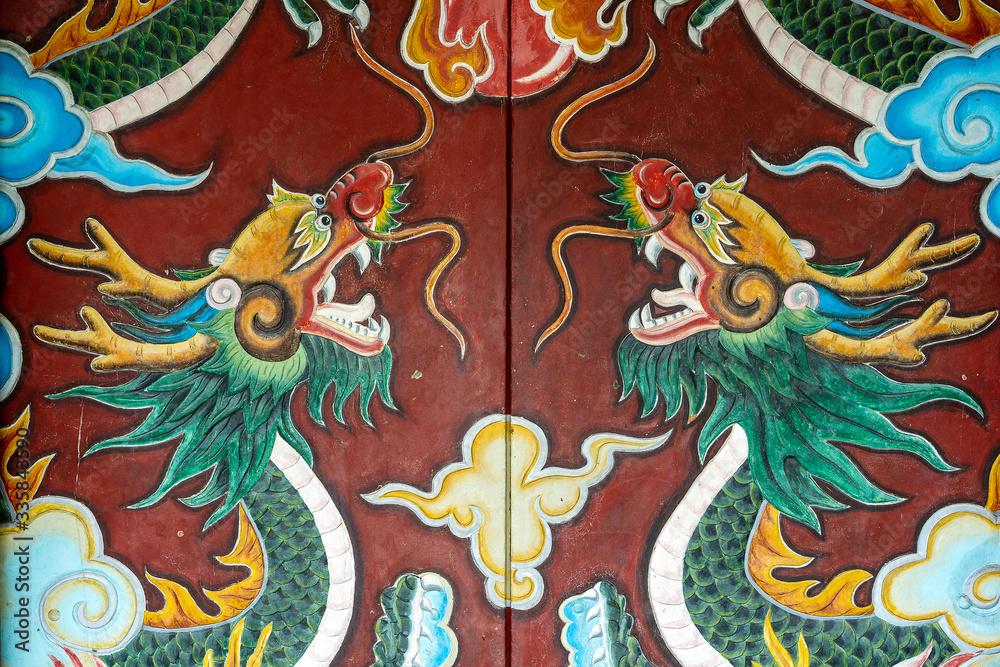 A dragon painting at the gate of an ancient temple in Hoi An old town, Vietnam. The dragon pattern of ancient Chinese art , Dragon painting in temple door