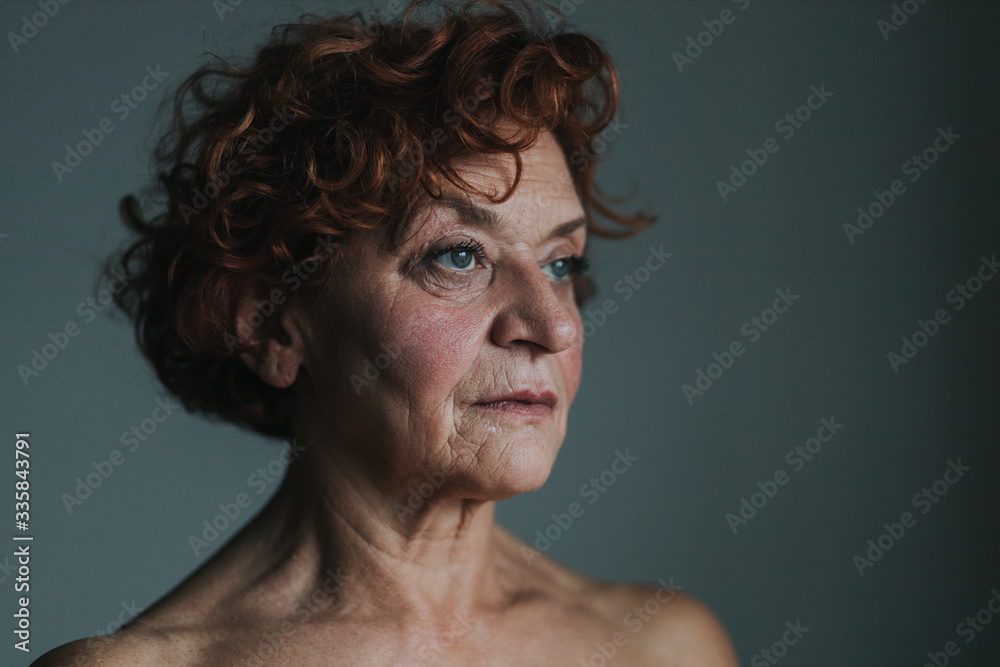 Mature woman by the window thinking about life Mature woman by the window thinking about life