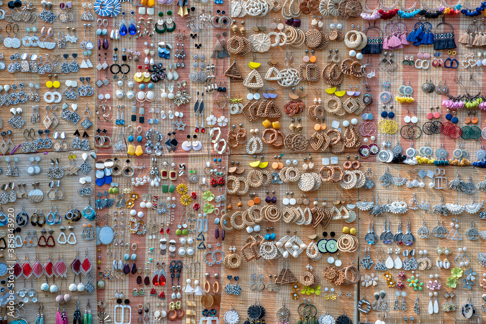 Fototapeta premium Colorful handmade earrings for sale for tourists at the street market in Hoi An old town, Vietnam