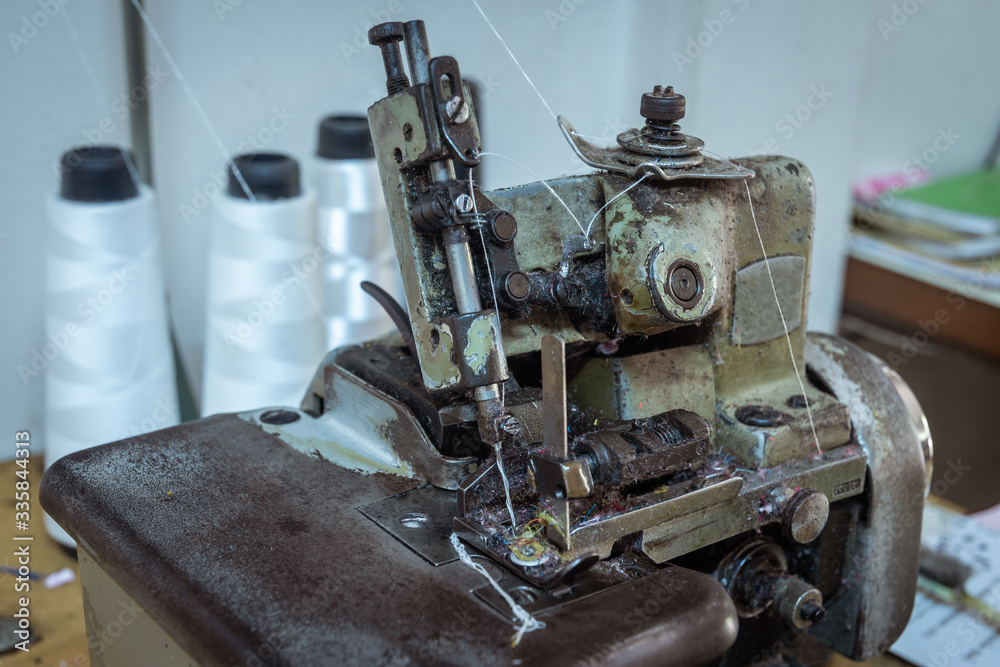 Sewing machine on table in workshop Sewing machine on table in workshop